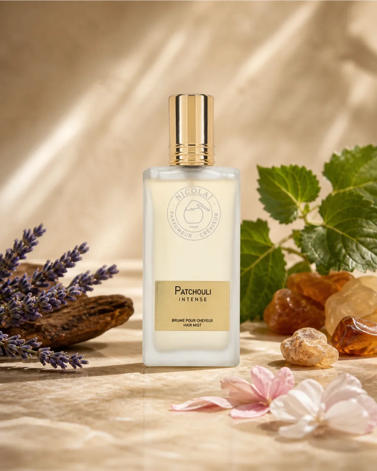 NICOLAI PATCHOULI INTENSE HAIR MIST 50ml fragrance bottle in a scent-inspired setting